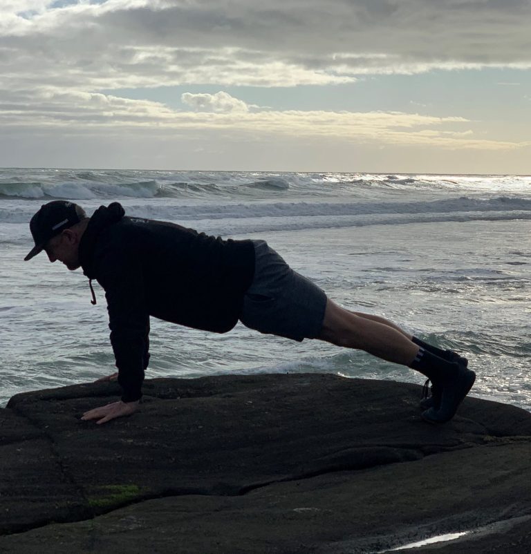 Man over 40 doing some body weight training as part of online fitness programme