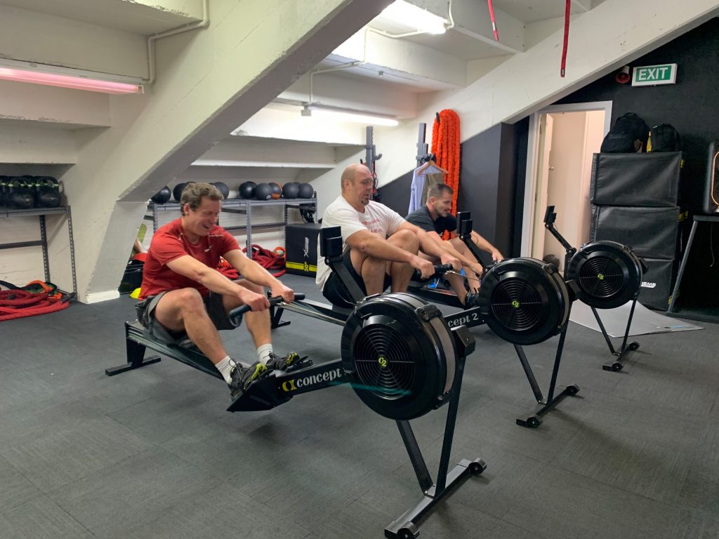 Men over 40 rowing during a coach-led training session at Body Torque Gym Newmarket
