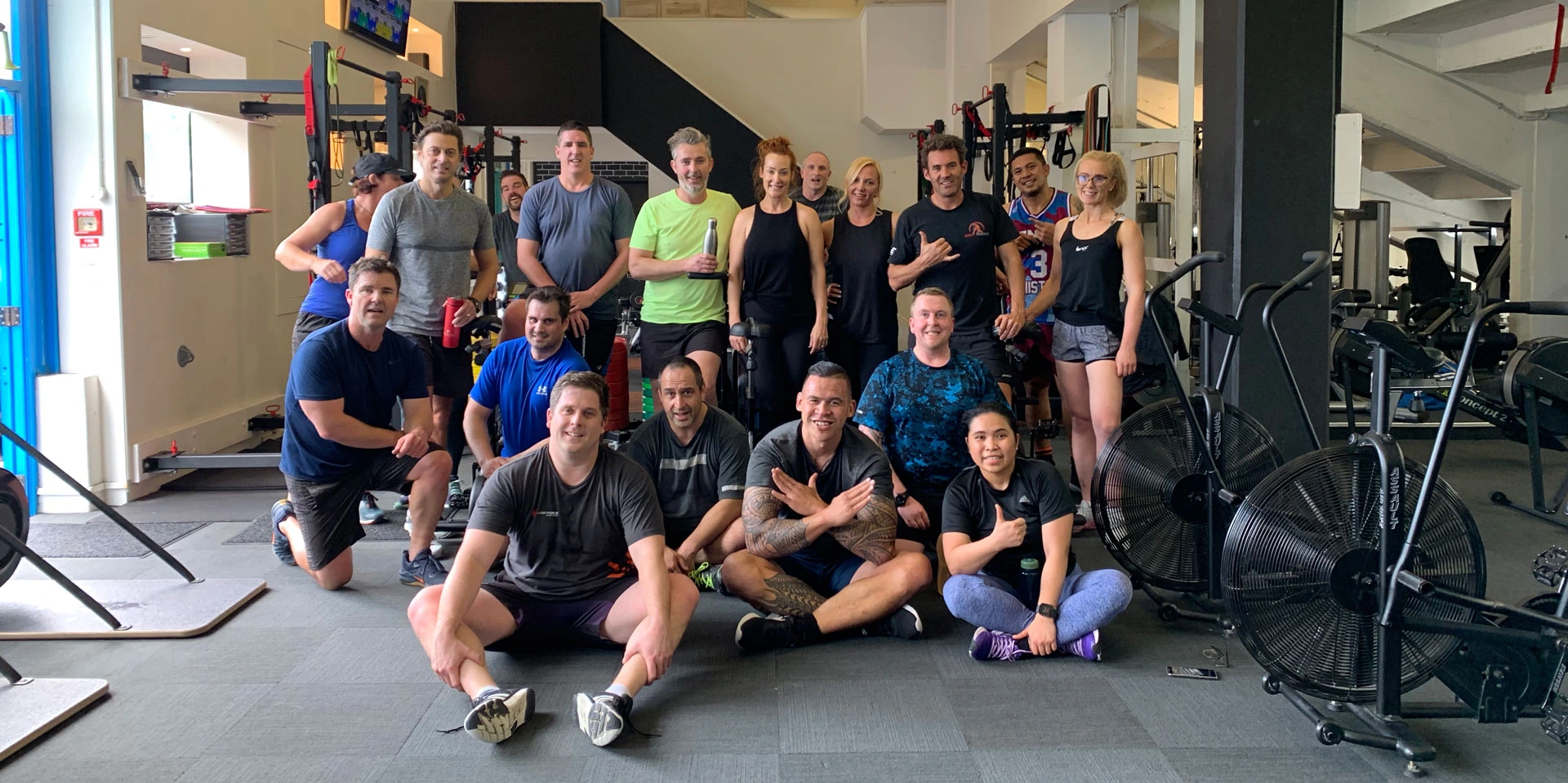 Body Torque Gym community in Newmarket, Auckland. Men and women over 40 after a workout posing for a photo demonstrating the supportive and friendly environment.