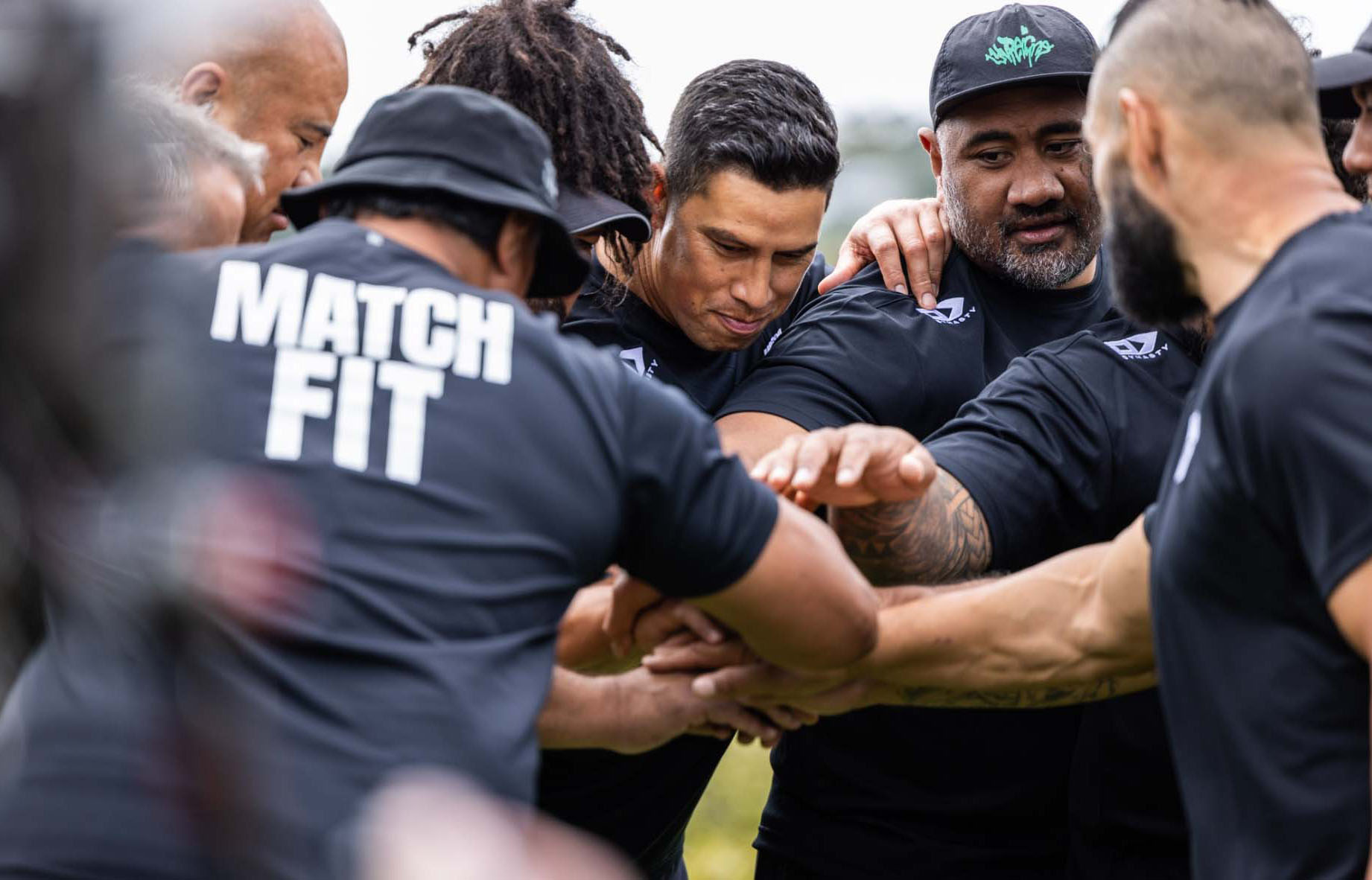 Group of men over 40 in a fitness support huddle before training session as seen on TV3's Award winning Matchfit Series