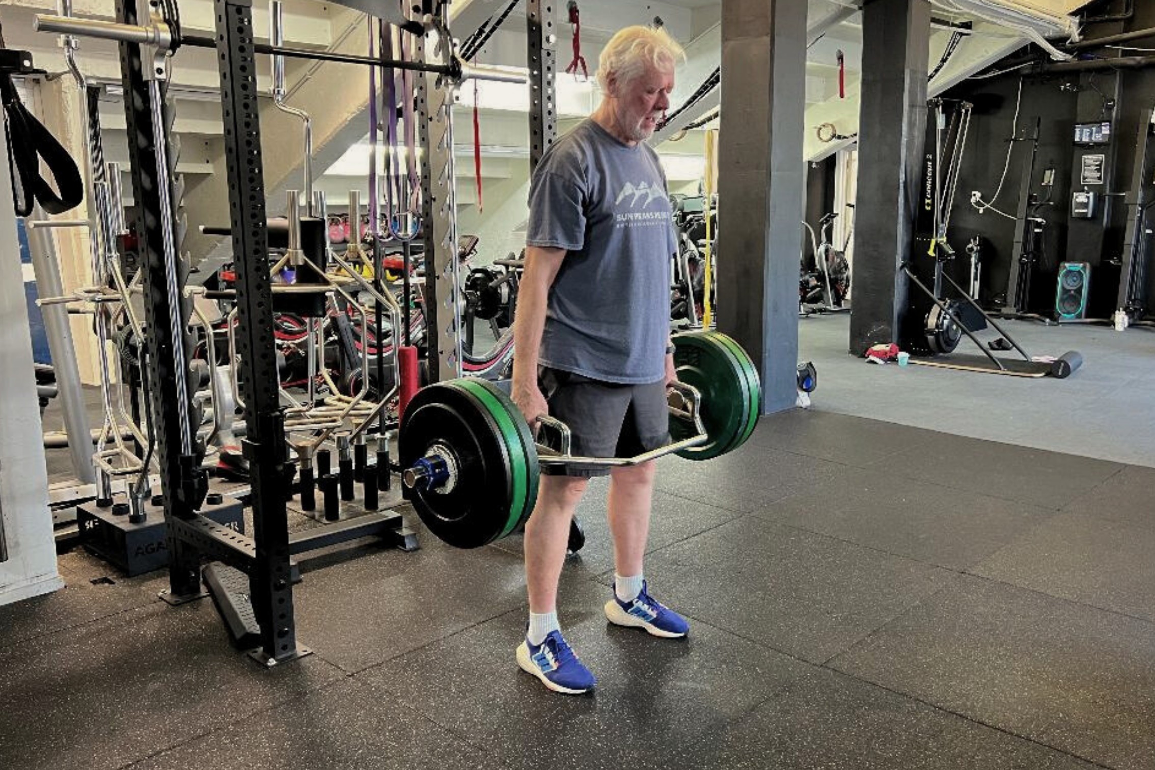 Phil, a 76-year-old personal training client at Body Torque Gym in Newmarket, lifting weights as part of his strength training programme.